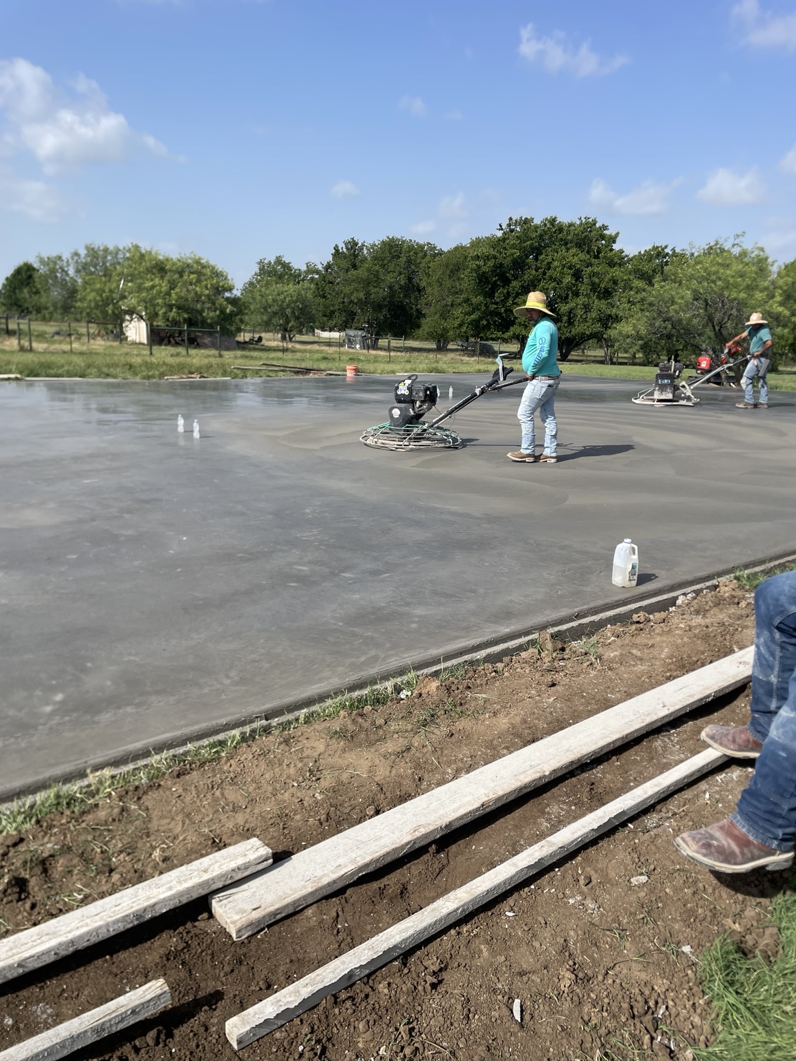 Concrete crew finishing a freshly poured slab